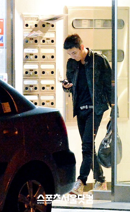 올 블랙 패션에 화려한 금색 신발로 포인트를 준 이특이 스튜디오를 빠져나오고 있다.