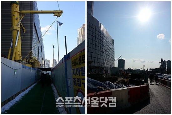 제2롯데월드 공사 현장 인근에 마련된 임시 보행자 통로 위에는 거대한 건설 장비들이 건설자재들을 옮기고 있다.