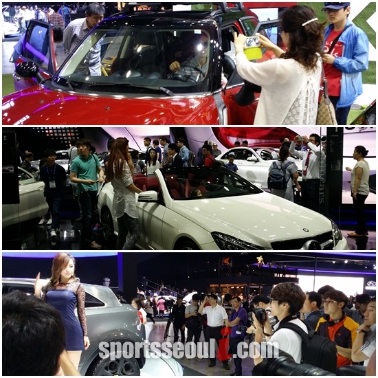 연인, 가족, 친구 등으로 구성된 관람객들이 2014 부산 모터쇼를 찾아 자동차를 둘러보고 있다.