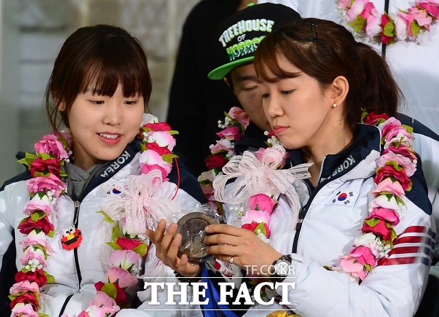 이때가 좋았는데 김아랑(왼쪽)과 전지수가 지난해 2월 25일 열린 2014 소치 동계올림픽 대표팀 귀국 행사에서 메달을 만지고 있다. / 인천국제공항 = 이새롬 기자