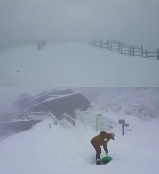 강원도 한 산의 산악대피소에 눈발이 휘몰아치고 있는 가운데 산악관리인이 눈을 치우고 있다. / 유튜브 영상 캡처