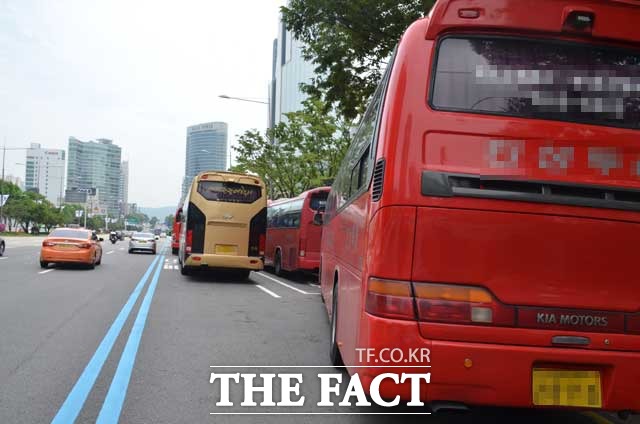 관광버스들이 21일 오후 서울 강남구 아셈타워 앞에서 길게 줄지어 주·정차하고 있다. 이 버스 가운데 일부는 시동을 켠 채 승객을 기다리고 있었다. /장병문 기자