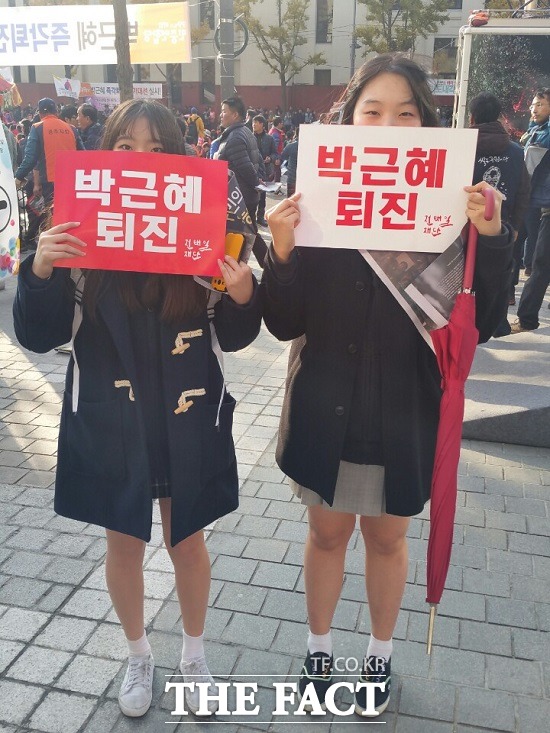 경기 동두천과 양주에서 왔다는 고교 1년생 권모(16·왼쪽) 양과 김모(16) 양이 12일 오후 서울 광화문대로에서 박근혜 퇴진이라고 쓰인 피켓을 들고 있다./종로=신진환 기자