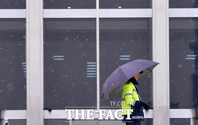 서울에 첫눈이 내린 20일 오후 서울 여의도 국회에서 경찰이 우산을 쓰고 경비를 서고 있다. /문병희 기자