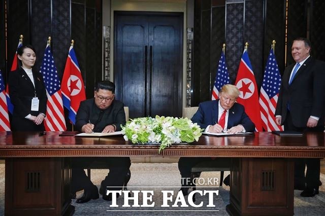 김정은 위원장과 트럼프 대통령이 정상회담 합의문에 서명하고 있는 모습. /싱가포르 통신정보부 제공