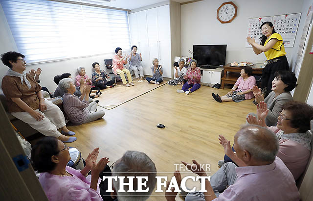 김 여사가 보건소 방문 간호사의 폭염 대비 안전 수칙에 대해 마을 어르신들과 함께 설명을 듣고 있다./청와대 제공