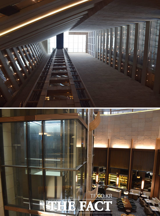 사진 위는 2층 라운지에서 천장을 바라 본 모습. 아래는 유리로 된 엘리베이터.