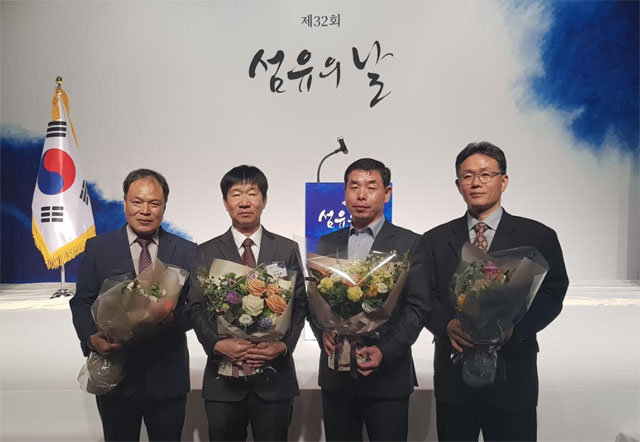 지난 9일 서울 테헤란로에서 열린 제 32회 섬유의 날에서 정부 포상을 받은 태광그룹 임직원들이 기념 촬영을 하고 있다. 왼쪽부터 태광산업 강춘길 기장, 김석환 기장, 대한화섬 우종찬 기장, 박종수 기장. /태광그룹 제공