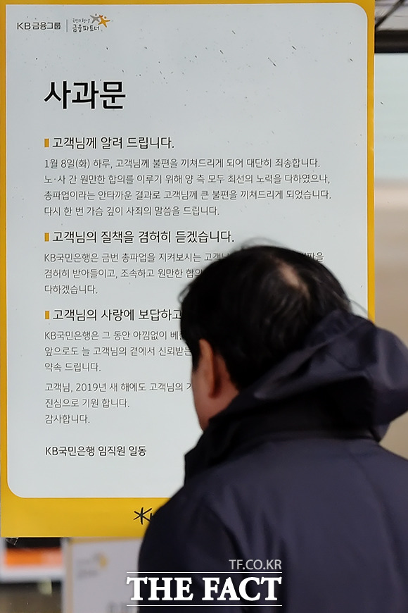 KB국민은행이 총파업에 돌입한 8일 오후 서울 영등포구 국제금융로 KB국민은행 본점을 찾은 고객이 입구에 붙어있는 안내문을 바라보고 있다. /이선화 기자