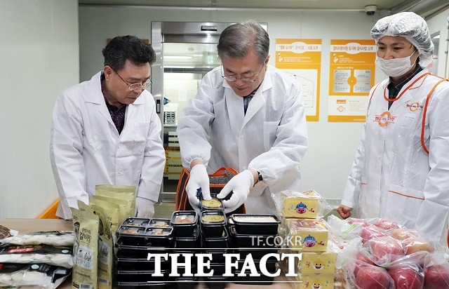 문재인 대통령이 1일 오전 서울 관악구 행복도시락 사회적협동조합 관악센터에서 최영남 나눔공동체 대표와 함께 도시락 포장을 하고 있다. /청와대 제공