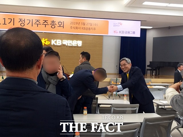 윤종규 KB금융지주 회장(오른쪽)이 이날 주주총회에 참석한 한 주주와 악수를 나누고 있다. /여의도=지예은 기자