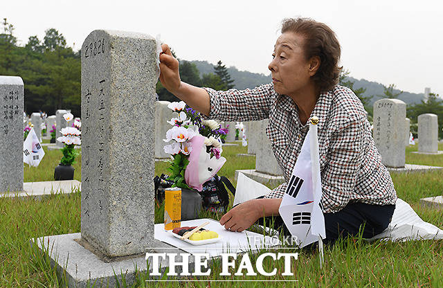 제 64회 현충일인 6일 오전 서울 동작구 국립서울현충원을 찾은 한 참배객이 묘비를 닦고 있다. /이새롬 기자