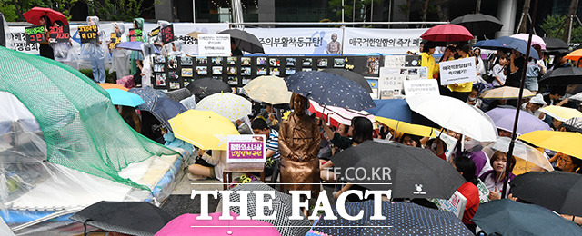 집회 도중 갑작스레 내리는 비. 모두가 우산을 쓰고 집회를 이어가는데...