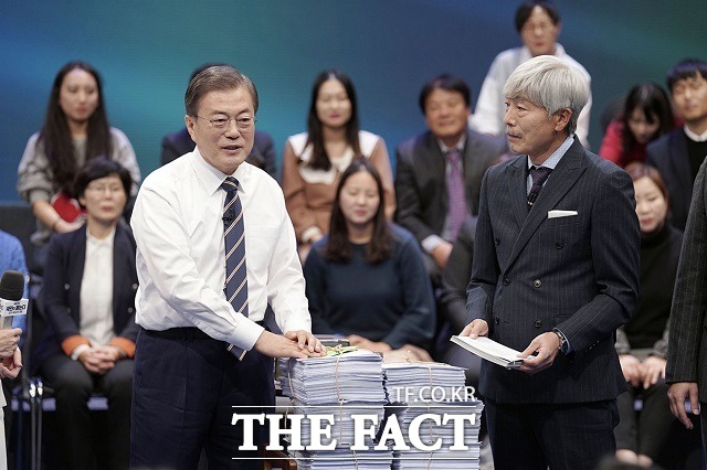 문재인 대통령이 19일 오후 서울 MBC 미디어센터에서 열린 국민이 묻는다, 2019 국민과의 대화에 참석해 국민패널과 온라인 참여자 질문지를 받고 있다. /청와대 제공