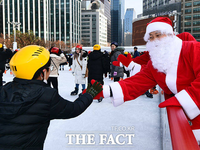 크리스마스인 25일 오후 서울 중구 시청광장 스케이트장을 찾은 시민들이 산타분장을 한 직원들과 인사를 나누고 있다. /이동률 기자