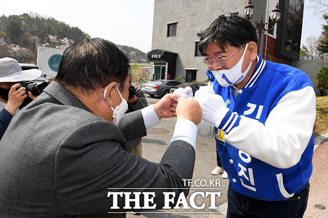 민주당 믿어주세요~ 김용진 경기 이천 후보(오른쪽)가 설봉공원 앞에서 시민들과 주먹 인사를 나누고 있다.