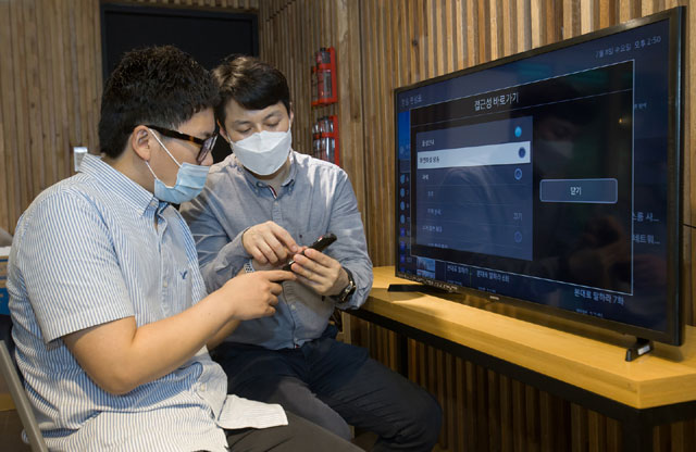 삼성전자 상품전략팀 직원이 서울 관악구에 있는 실로암 시각장애인 복지관에서 한 시각장애인에게 삼성전자 스마트 TV의 접근성 기능에 대해 설명하고 있다. /삼성전자 제공