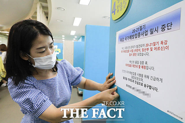 성동구보건소 직원이 22일 오전 서울 성동구 성동구보건소 예방접종실에서 무료 예방 접종 계획을 일시 중단한다는 내용의 안내문을 부착하고 있다. /뉴시스