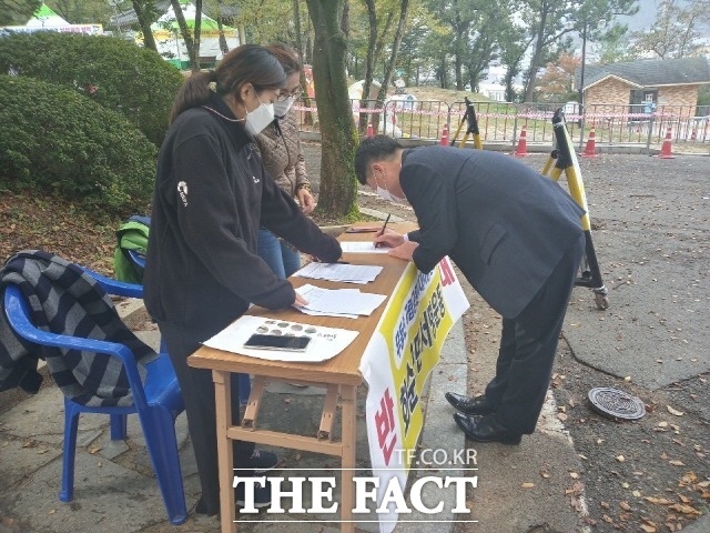 무등산 국립공원 추가 지정하는 정부 방침에 반대하는 서명운동에 한 군민이 서명하고 있다./ 화순군 제공