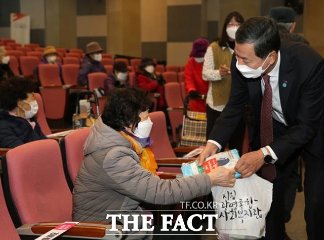 김성택 기금조성총괄본부장(오른쪽)이 3일 광명종합사회복지관을 찾아 어른신들께 방역 마스크와 간편식을 전달하고 있다./기금조성총괄본부 제공