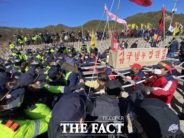 포항 장기면주민들이 국방부장관·한미연합사령관 문구가 적힌 상여를 메고 포항수성사격장으로 행진을 펼치자 경찰들이 막아서고 있다/포항수성사격장반대대책위원회 제공