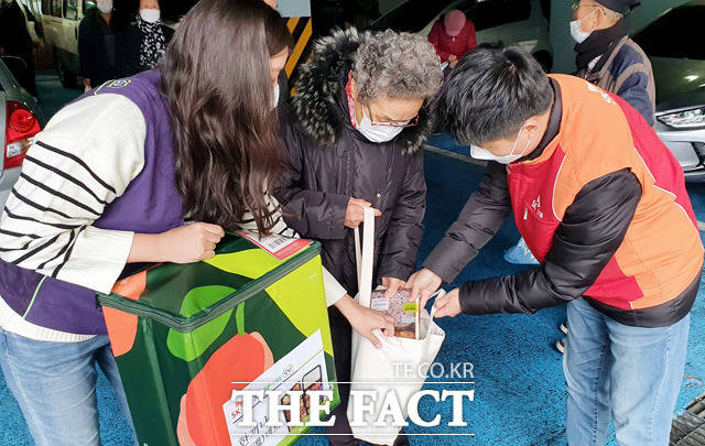 SK건설과 BGF리테일은 코로나19로 식사해결이 어려운 어르신에게 도시락을 전달하는 한 끼 나눔 온(溫)택트 행사를 실시한다고 9일 밝혔다. 사진은 지난 2일 SK건설과 BGF리테일 구성원이 도시락을 어르신분께 전달하고 있는 모습. /SK건설 제공