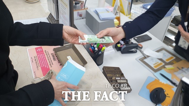지난 9일 서울 여의도에 위치한 한 은행 영업점을 찾은 한 고객이 신권을 교환하고 있다. /정소양 기자