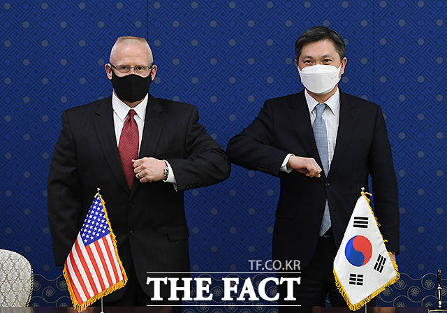 팔꿈치 인사하는 김상진(오른쪽) 국방부 국제정책관과 토마스 디 와이들리 주한미군사 기획참모부장.