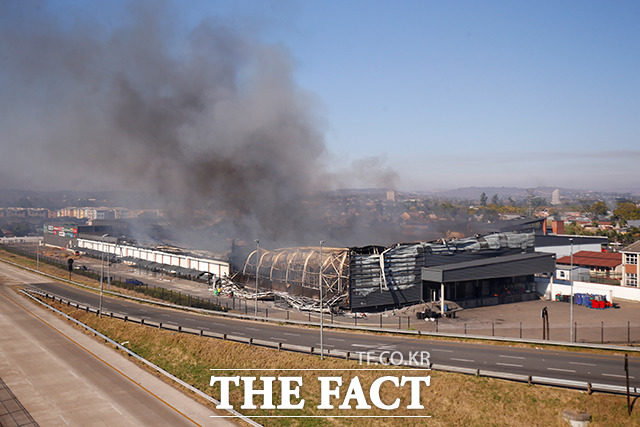 12일(현지시간) 남아프리카공화국 피터마리츠버그에 위치한 대형 쇼핑몰이 약탈 당한 후 불타고 있다. /피터마리츠버그=로이터