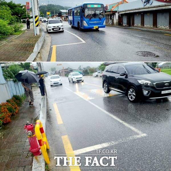 봉화군의 대표관광지 봉성숯불단지에 조성된 노상주차장이 관련법규를 모두 무시해 논란이다. 갓길에 불법조성된 노상주차 차량을 피해 버스가 중앙선을 넘어 운행하고 있다./봉화=이민 기자