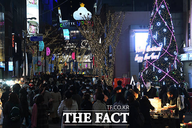 성탄절을 이틀 앞둔 23일 오후 서울 중구 명동을 찾은 시민들이 트리 앞에서 즐거운 시간을 보내고 있다. /남용희 기자