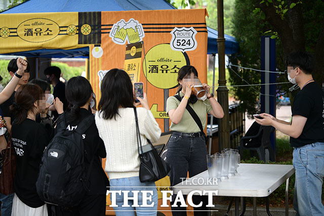 18일 오후 서울 동대문구 서울시립대에서 대동제가 대면 축제로 열린 가운데 한 학생이 입점 업체가 진행한 맥주 빨리 마시기 이벤트에 참여하고 있다. /남윤호 기자
