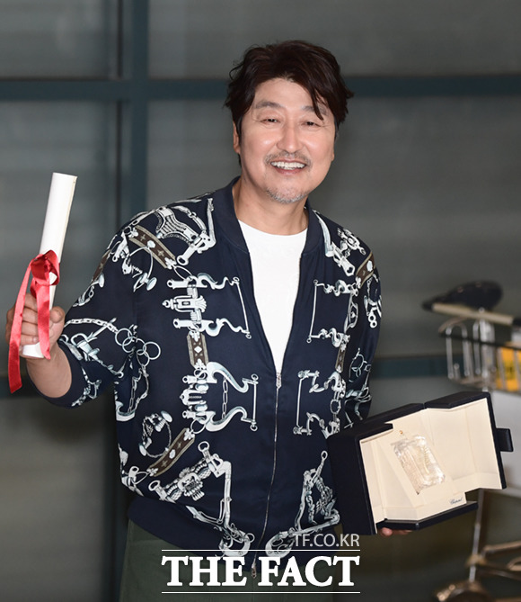 송강호가 30일 오후 인천국제공항을 통해 귀국한 후 트로피를 들어보이고 있다. /이새롬 기자