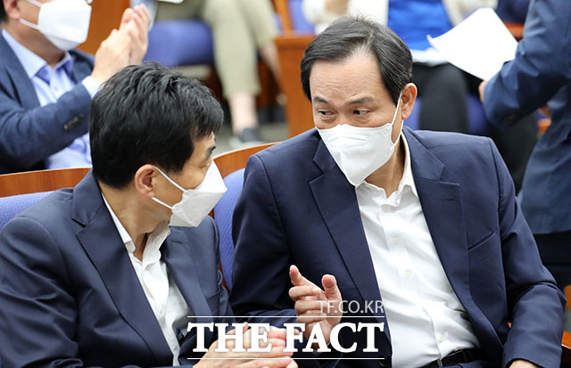 의원총회에 참석한 우상호 비대위원장이 김민기 의원(왼쪽)과 대화하고 있다.