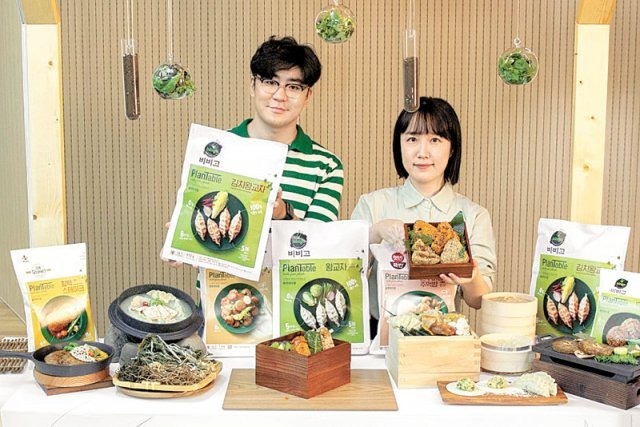 지난 18일 CJ제일제당 직원들이 식물성 식품 브랜드인 플랜테이블에서 출시한 김치왕교자와 주먹밥을 선보이고 있다. /CJ제일제당 제공