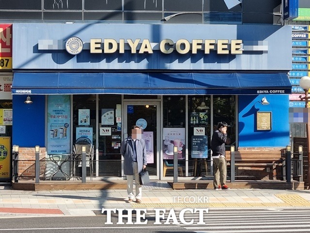 이디야커피가 최근 잠정 보류했던 음료 사이즈 상향 조정과 가격 조정 시행을 위한 움직임을 보이고 있다, 한 시민이 이디야 커피 매장 앞에 서 있다./이선영 기자