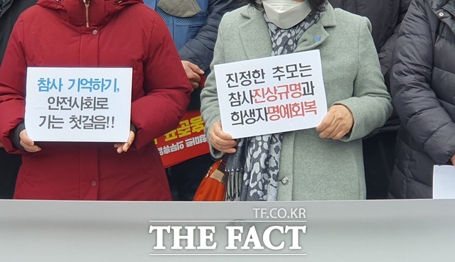추모위원회 회원들이 대구지하철 참사에 대한 피켓을 들고 서 있다. /대구=김채은 기자