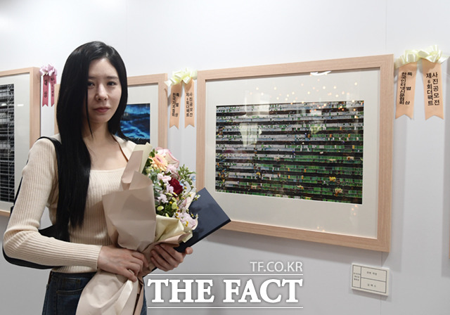 인터넷신문협회상 수상자인 김택수 씨를 대신해 참석한 딸 다은 씨가 작품과 함께 기념촬영하고 있다.