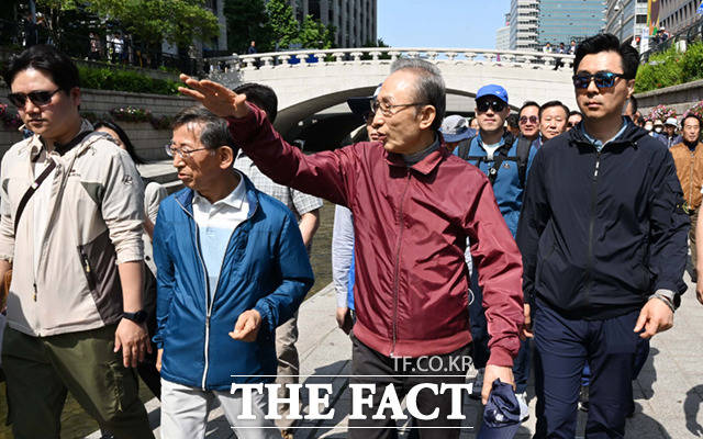 이명박 전 대통령이 15일 서울 청계광장에서 청계천을 사랑하는 모임(청사모) 구성원들과 청계천을 산책하고 있다.