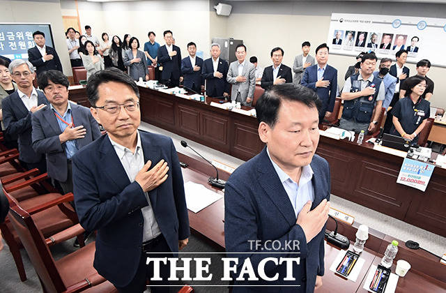 박준식 위원장과 위원들이 제6차 전원회의 시작에 앞서 국민의례를 하고있다.