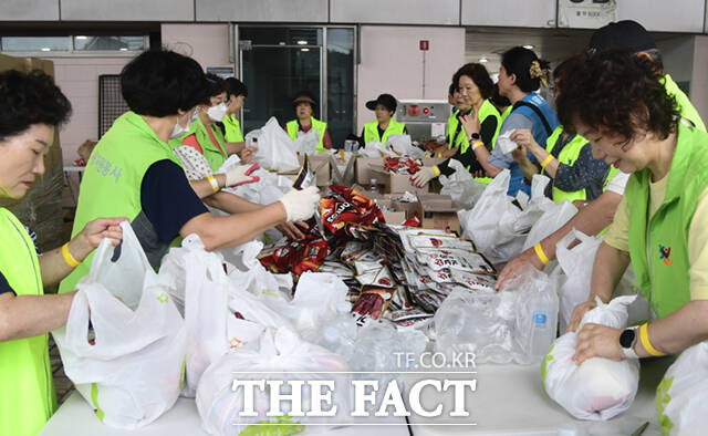 서울시 자원봉사자들이 스카우트 대원들에게 나눠줄 간식을 소분하고 있다.