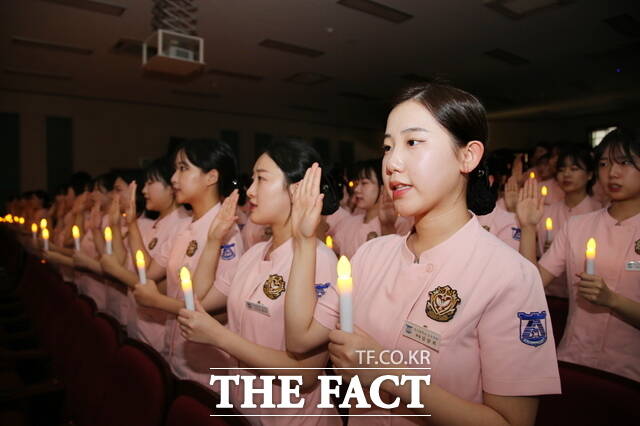 22일 동신대학교 나래관 소강당에서 열린 제26회 나이팅게일 선서식에 참가한 간호학과 재학생 157명이 촛불 앞에서 나이팅게일의 숭고한 희생·봉사의 길을 걷겠다며 선서하고 있다./동신대학교