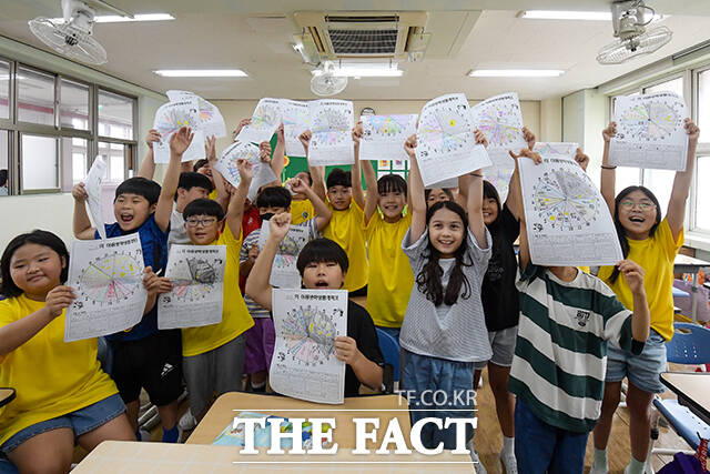 19일 오전 서울 동작구 대림초등학교에서 여름 방학식을 마친 4학년 5반 학생들이 여름 방학 생활 계획표를 들어 보이며 환하게 웃고 있다. /장윤석 기자