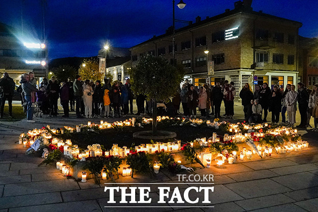 14일(현지시간) 노르웨이 콩스베르크의 화살 공격 현장에 주민들이 모여 꽃과 촛불을 놓고 희생자들을 추모하고 있다. / 콩스베르그=AP.뉴시스