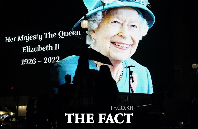 8일 엘리자베스 2세 영국 여왕의 서거 후 런던 피카들리 광장 대형 전광판 앞에 모인 시민들이 여왕의 얼굴 모습을 보며 애도하고 있다./런던=AP.뉴시스