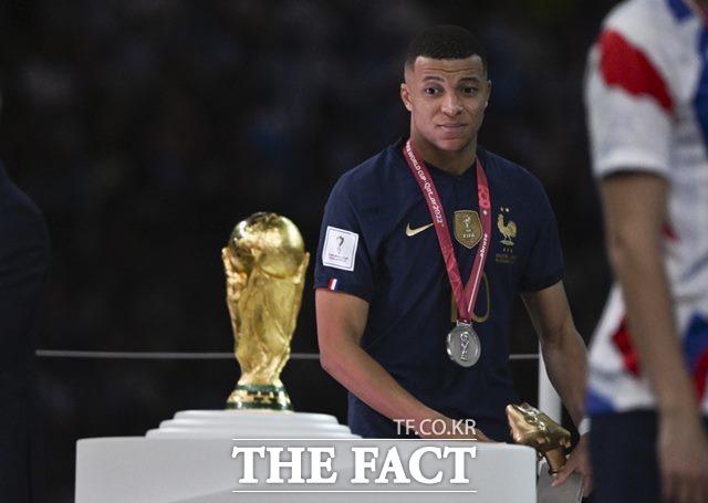 득점왕인 골든부트를 수상한 프랑스의 킬리안 음바페가 19일 2022 카타르 월드컵 시상식에서 복잡한 표정으로 월드컵 트로피를 바라보고 있다./루사일(카타르)=신화.뉴시스