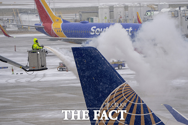 22일(현지시간) 미국 위스콘신주 밀워키 근교에 위치한 제너럴미첼국제공항에서 겨울폭풍으로 인해 얼어버린 항공기를 녹이는 작업이 진행되고 있다. /밀워키=AP.뉴시스