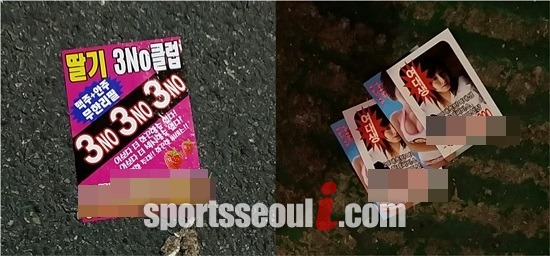 선수단 숙소 주변 거리 바닥에서 낯 뜨거운 전단지를 볼 수 있다.