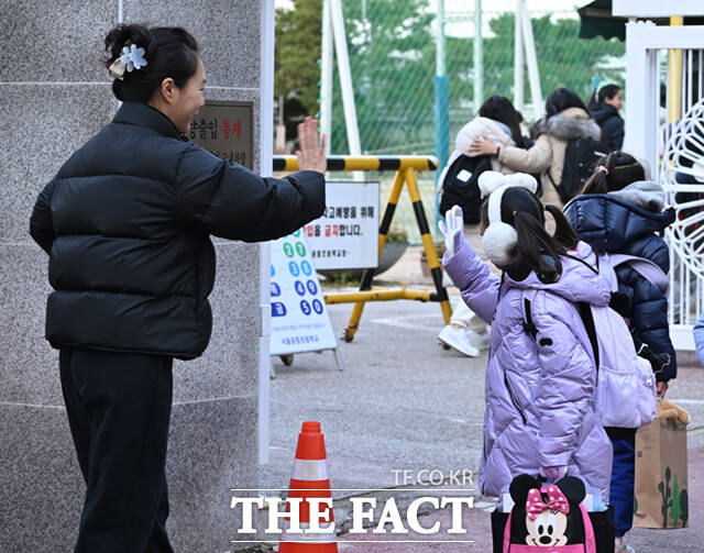 비상계엄령이 해제된 4일 오전 서울 영등포구의 한 초등학교 앞에서 한 어머니가 정상 등교하는 딸의 모습을 바라보며 손을 흔들고 있다. /이새롬 기자