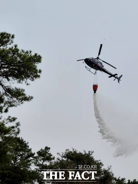 산불 진화 헬기가 산불을 향해 소방수를 뿌리고 있는 모습./고양